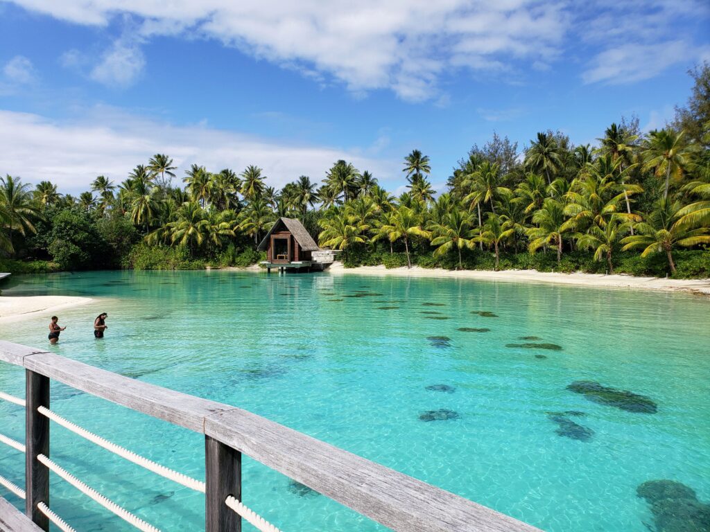 A couple in the water on the beach in Bora Bora.