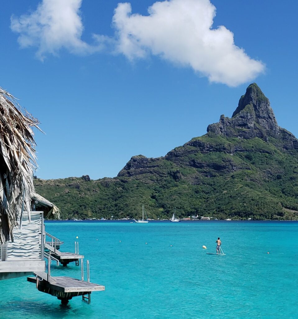 Man on a paddle boat in Bora Bora.