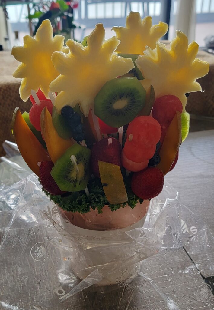 Food fruit bouquet gift - pieces of different types of fresh fruit on sticks arranged as a "bouquet".