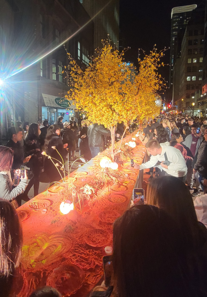 Large outdoor art exhibit on the street from Nuit Blanche Toronto with many people.