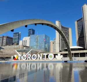 Colourful Toronto sign and fountain area at Nathan's Philips Square, free to visit in Toronto.