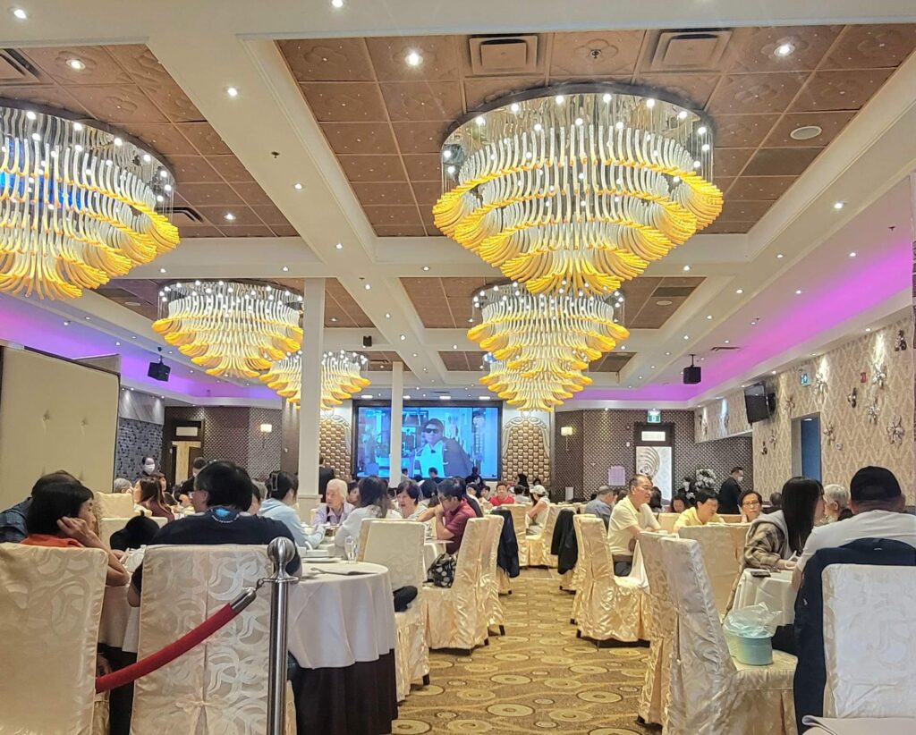 Interior of Skyview Fusion Cuisine restaurant in Markham Ontario with large chandeliers and elegant decor.