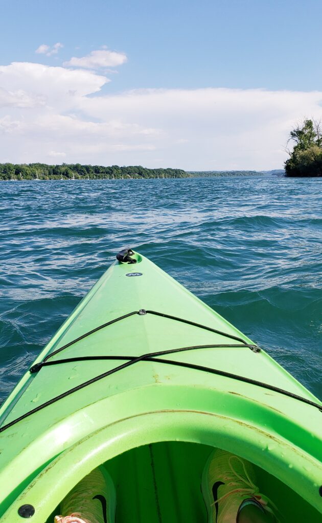 Front of a green kayak on a lake in Niagara-on-the-lake, Ontario, Canada.