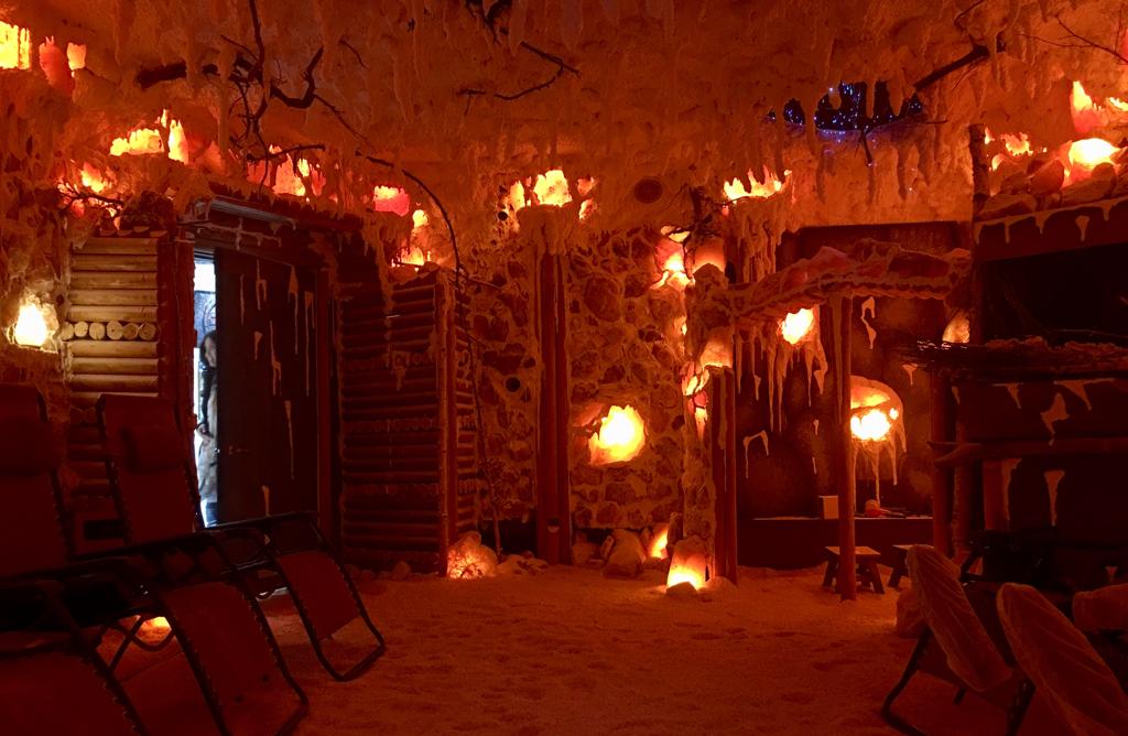 Salt cave that has chairs and salt lamps.