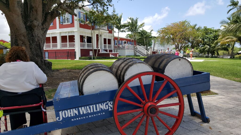 Decorative whiskey barrels in front of the colorful distillery.