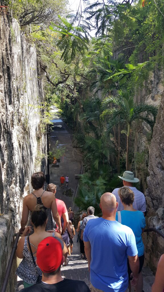 Visitors at the top of Queen's Staircase walking down toward the pathway.