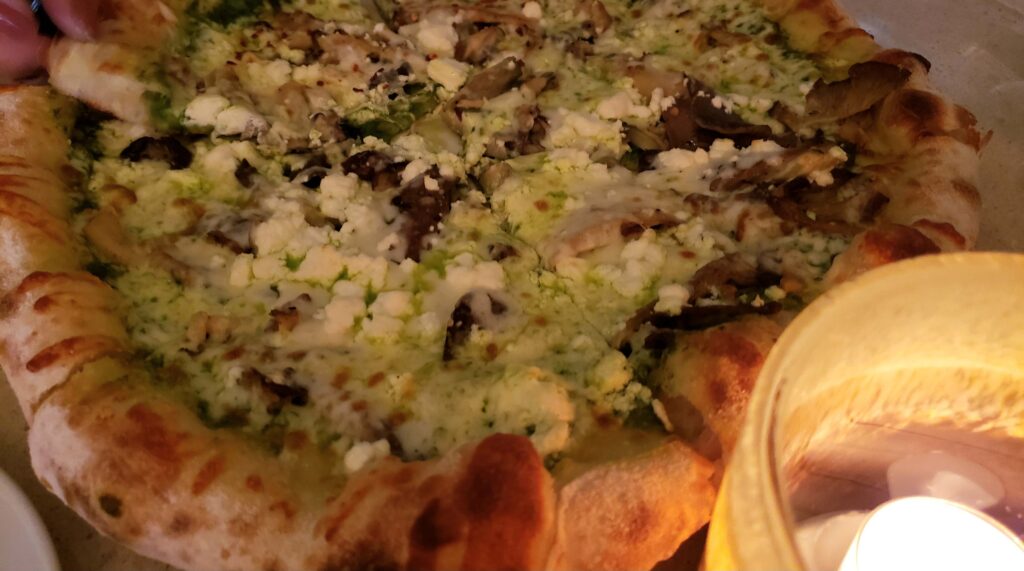 Close up of pizza, with lit candle, on table at Kitchen 76 restaurant in Niagara-on-the-lake.