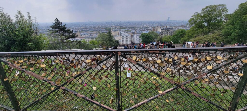 View from Montmartre in Paris, France and the fence covered with locks from visitors and tourists.