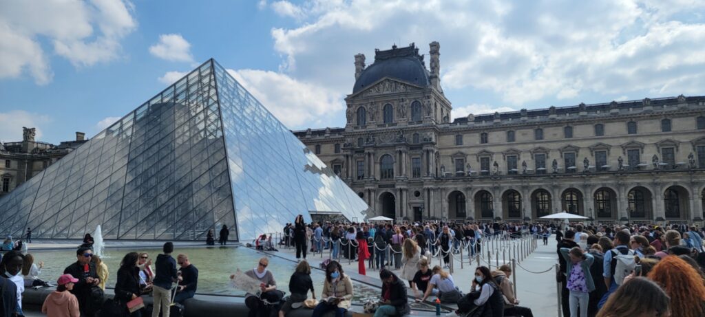 Long lines of visitors outside the museum entrance of the Louvre in Paris.