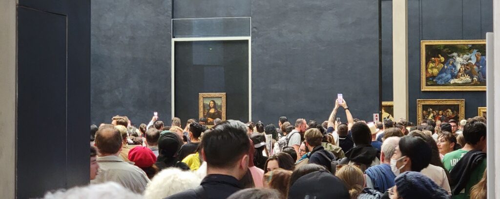 Crowds of people to see the Mona Lisa in the Louvre museum in Paris, France.