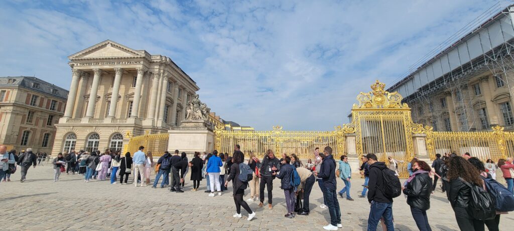 Long line up of visitors at the entrance of the Château de Versailles (Palace de Versailles), France.