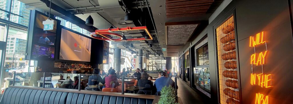 Bar area with high-top seating in the NBA Courtside restaurant.