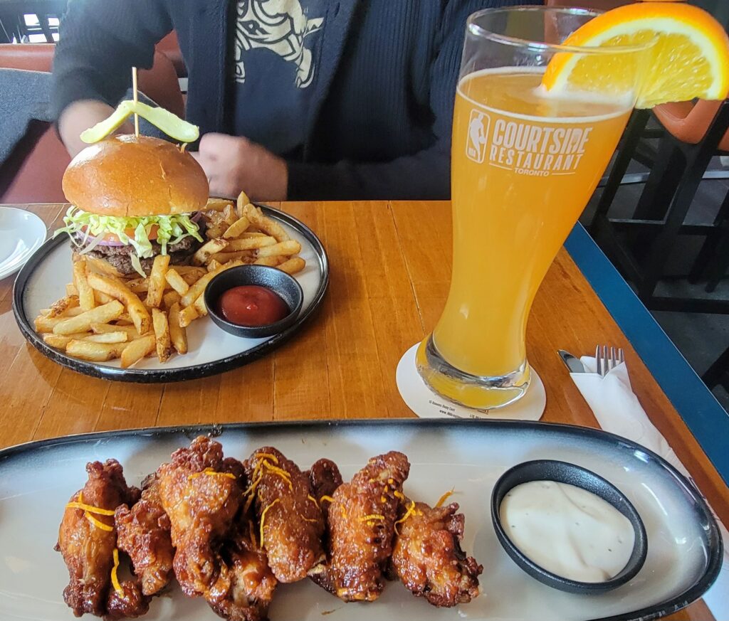 Burger and fries, chicken wings, and beer.