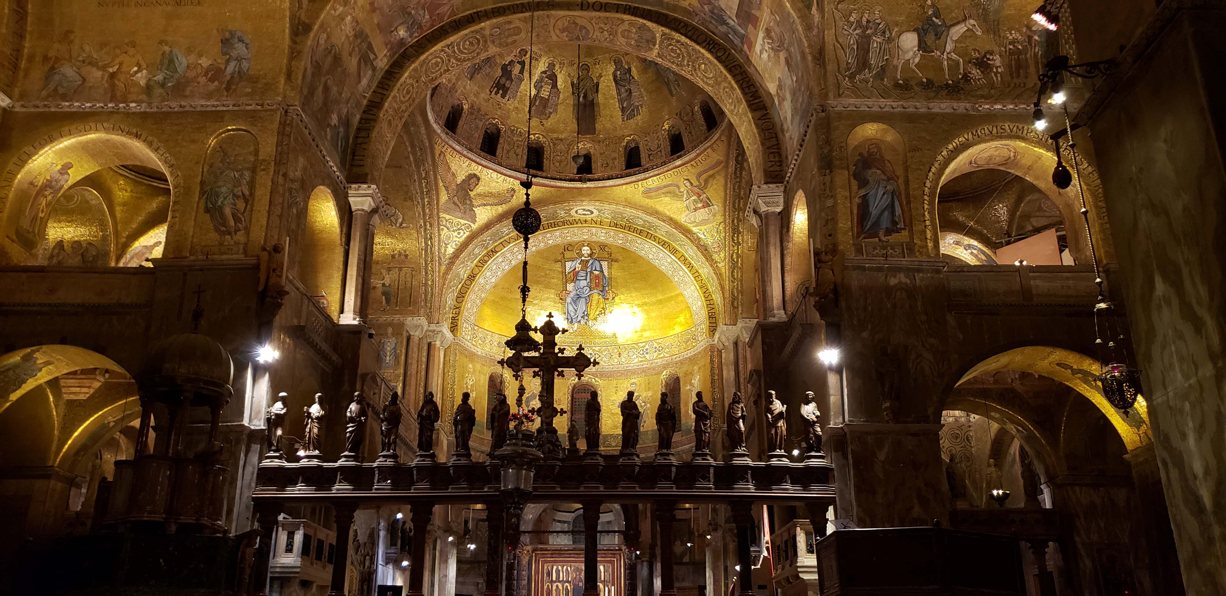 Gold mosaics inside seen during Saint Mark's Basilica tour in the evening.