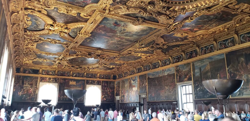 Grand and opulent gold ceiling with paintings.