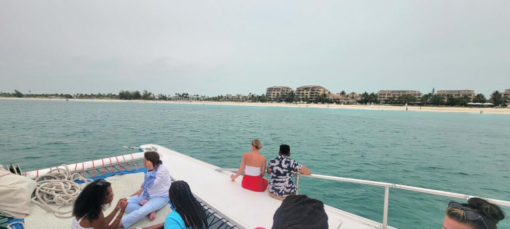 People on a catamaran with the islands in the background.