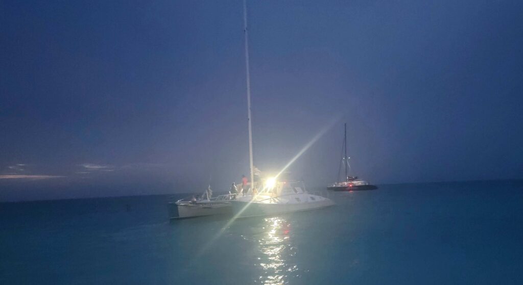 Picture of the catamaran at night from the shores of Grace Bay Beach in Turks and Caicos.