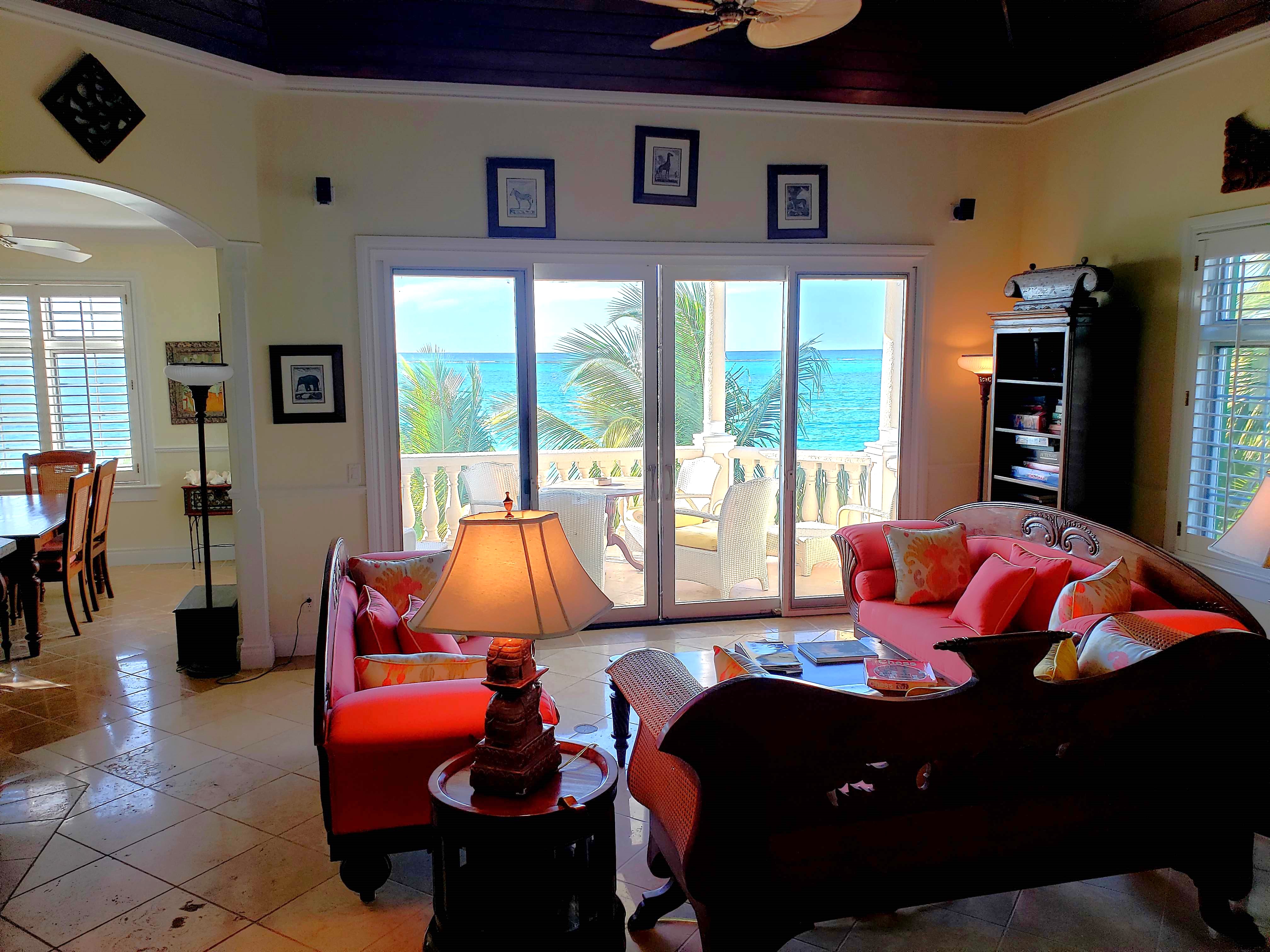 Elegant living room with sliding door to beautiful terrace and oceanfront views