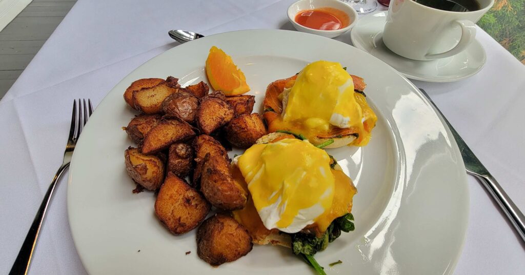 Eggs benedict with spinach and smoked salmon served with potatoes during our stay at The Charles Hotel.