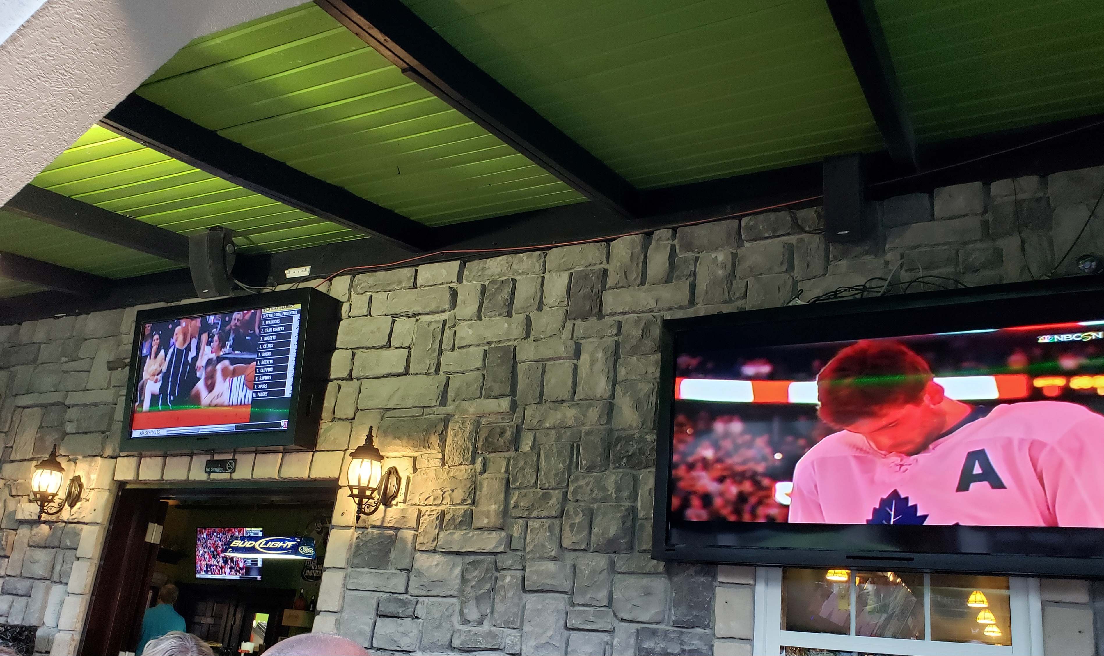 Two televisions on an exterior wall at Danny Buoy's in Grace Bay, Turks and Caicos.