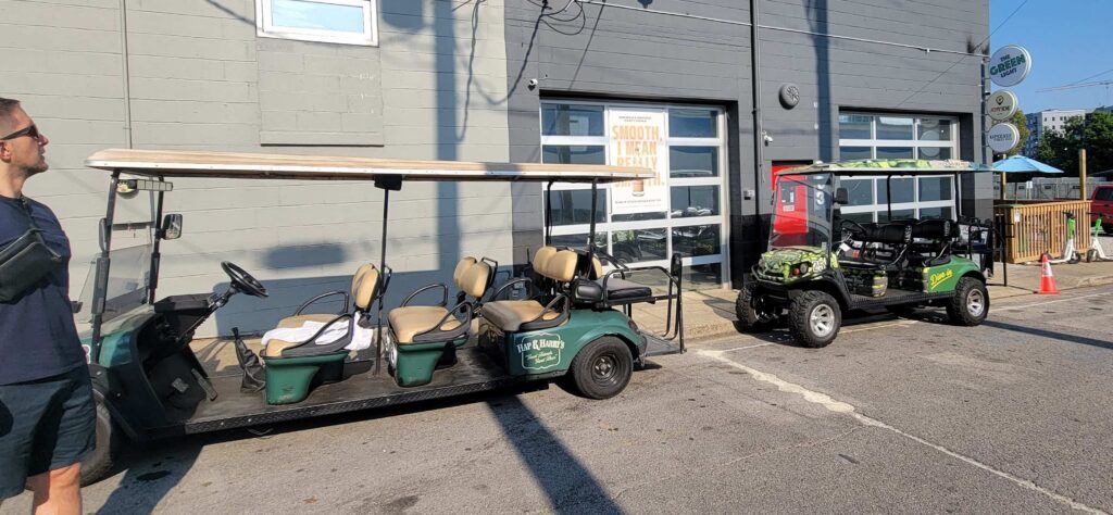 Two golf carts parked that are used in the Nashville Golf Cart Tours.