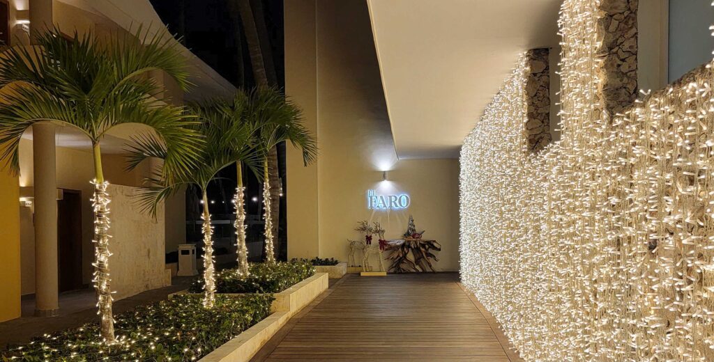 Exterior of El Faro restaurant at night with lights at Coral Level at Iberostar Selection Bavaro Suites.