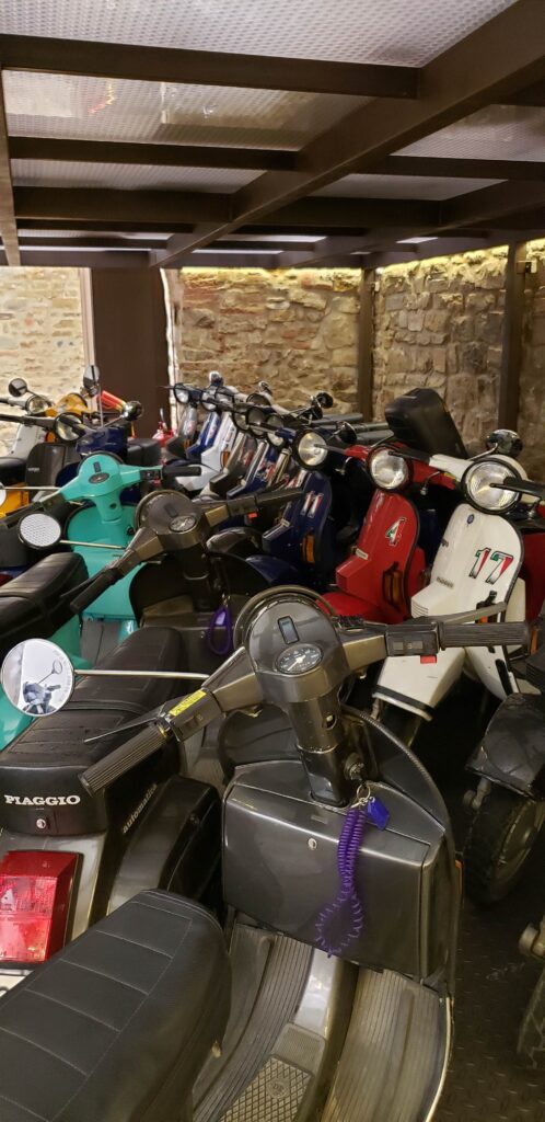 Vespas parked inside a building from the Florence Vespa Tour.