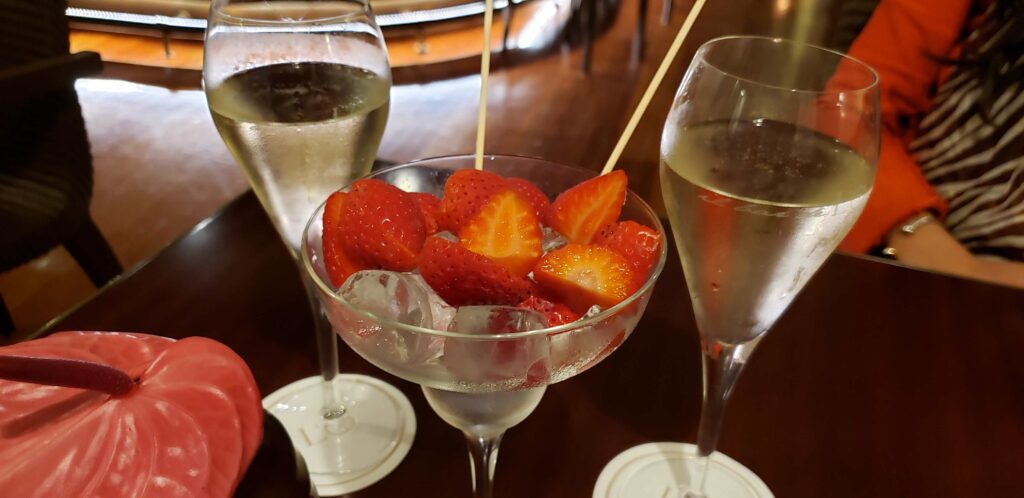 Two sparkling white wine and strawberries served in a glass.