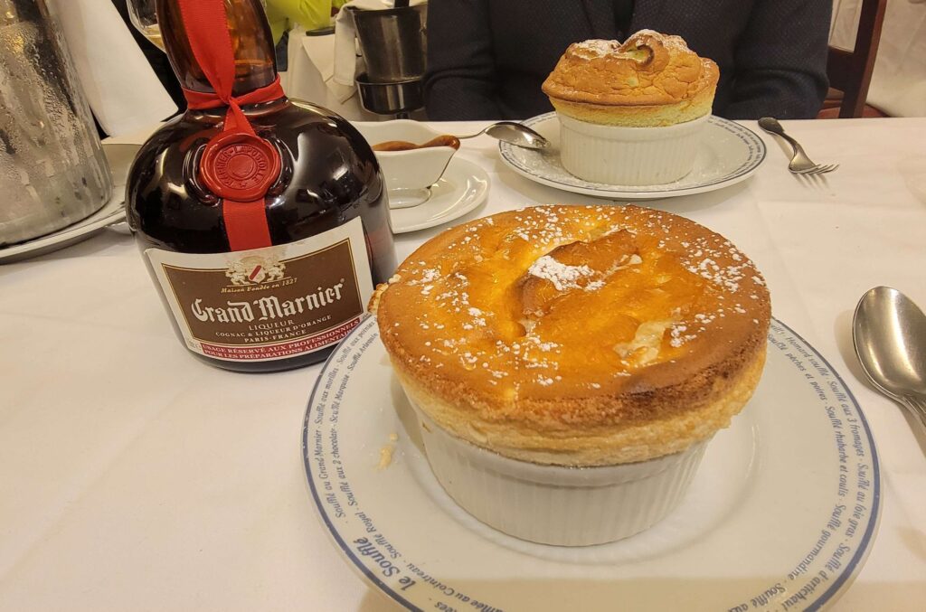 Grand Marnier souffle with a bottle of Grand Marnier at Le Souffle restaurant in Paris.