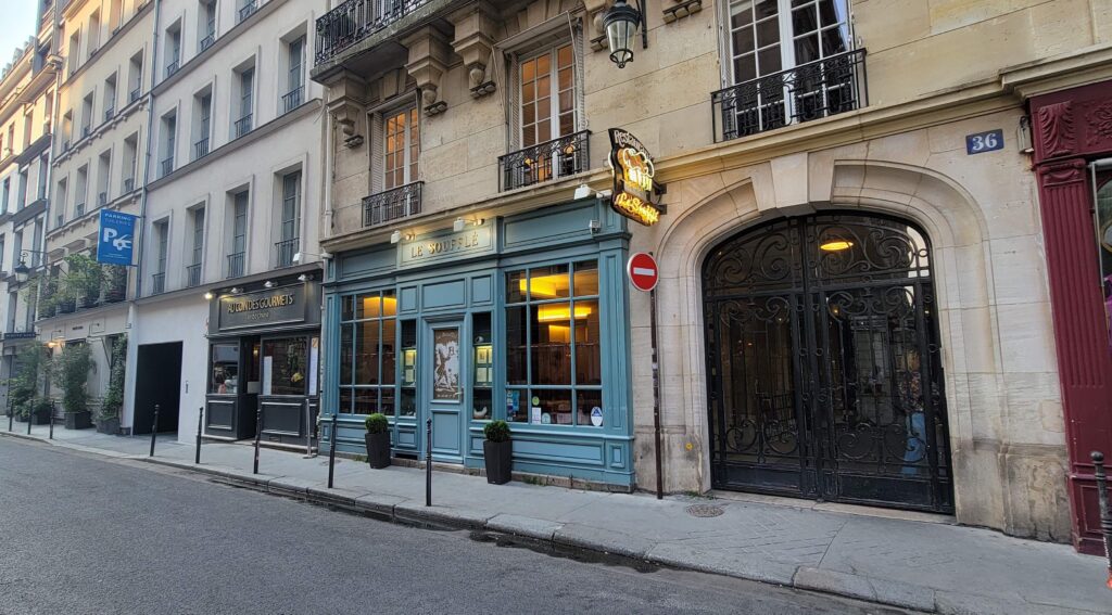 Exterior of Le Souffle restaurant with neighbouring stores in Paris.