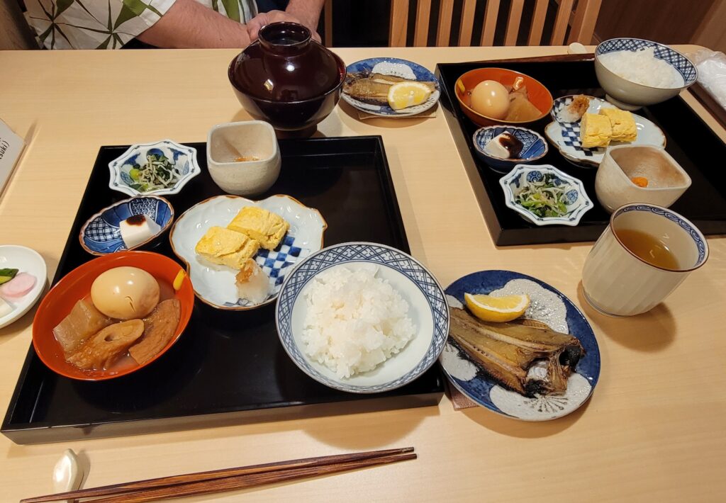 Obanzai breakfast served at our ryokan in Kyoto which includes eggs, fish, vegetables, rice, soup, and more.