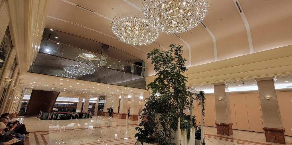 Grand lobby at Keio Plaza Hotel Tokyo with marble and chandeliers.