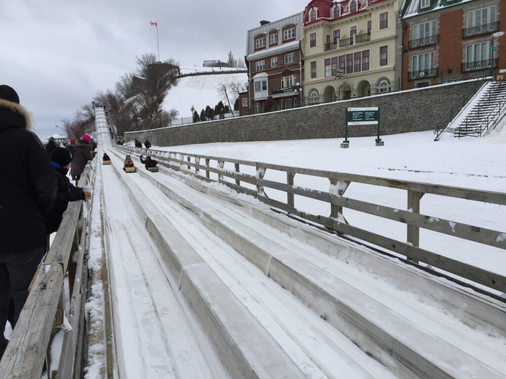 People on the toboggan ride at Dufferin Terrace in Quebec City on a winter day.