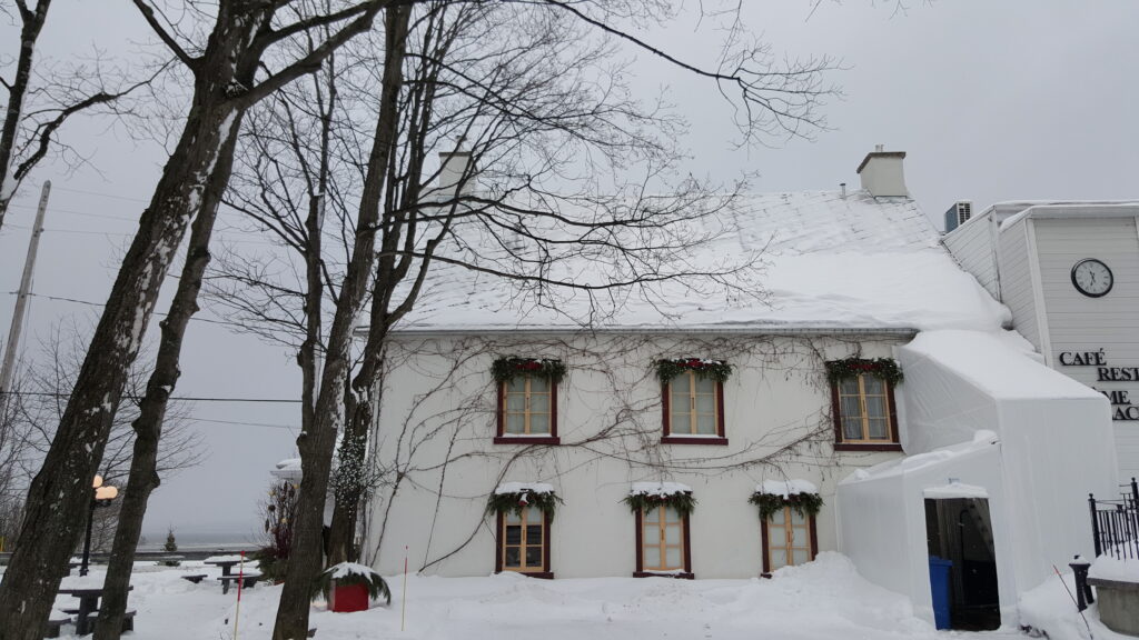 Snowy exterior of local chocolate shop, Chocolaterie de l'Ile d'Orléans, taken during our tour to Montmorency Falls in the winter.