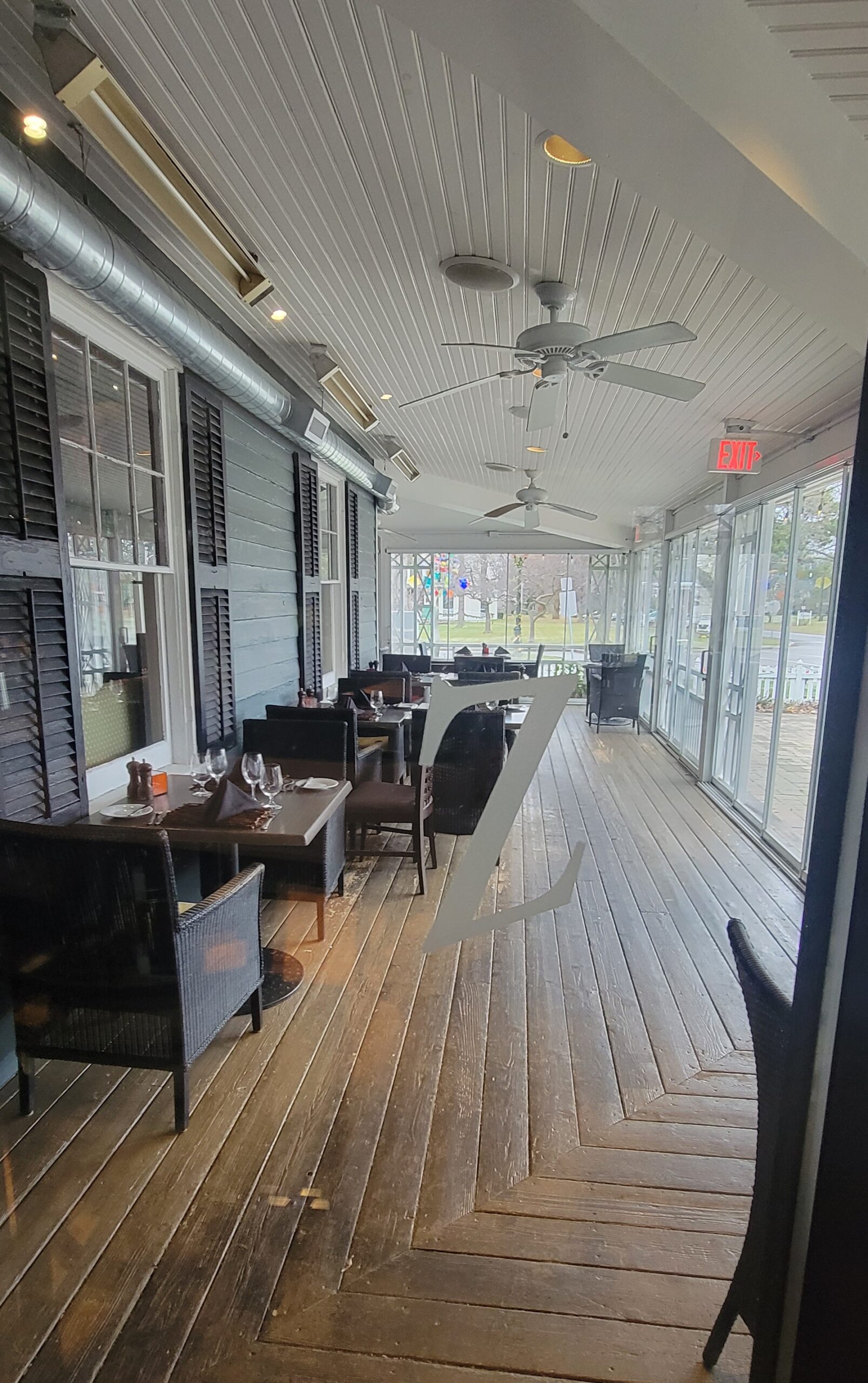 A section of the covered patio seating at Zees Grill.