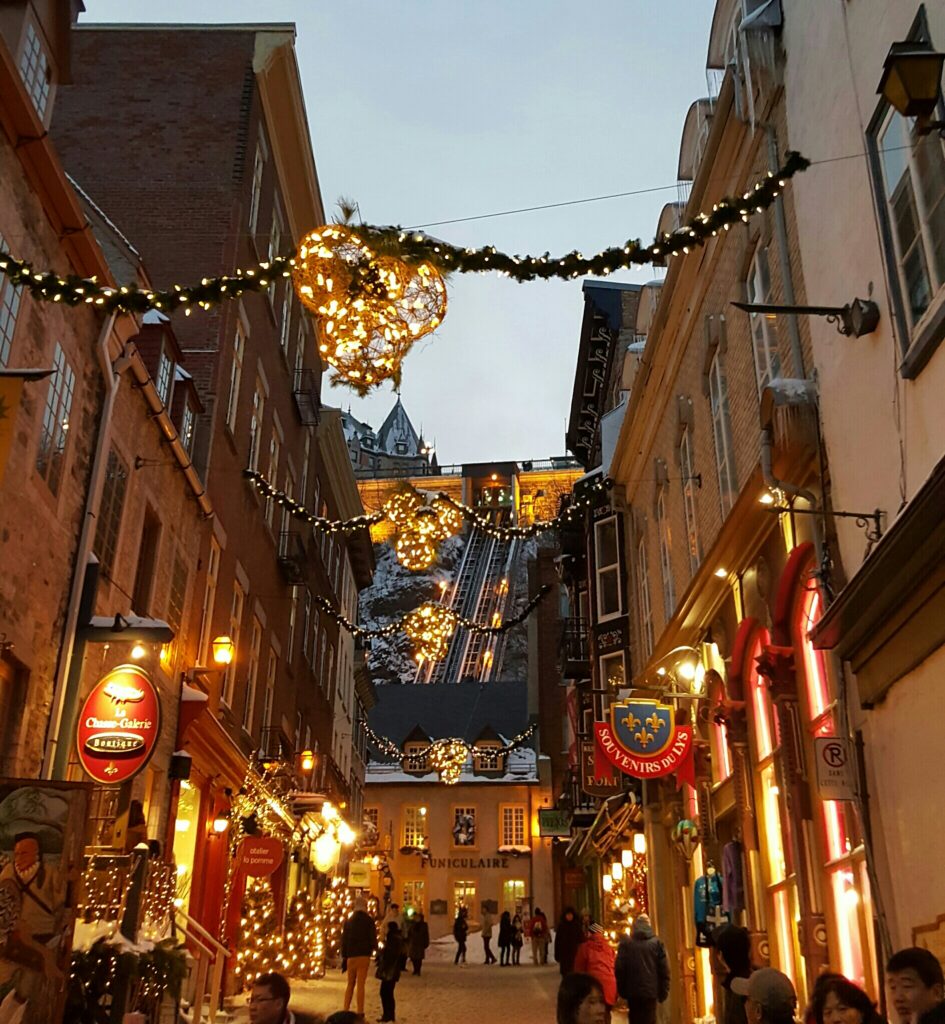 Exploring Old Quebec as pictured here in the evening, when decorated with Christmas lights and decor, is one of the best free things to do in Quebec City.