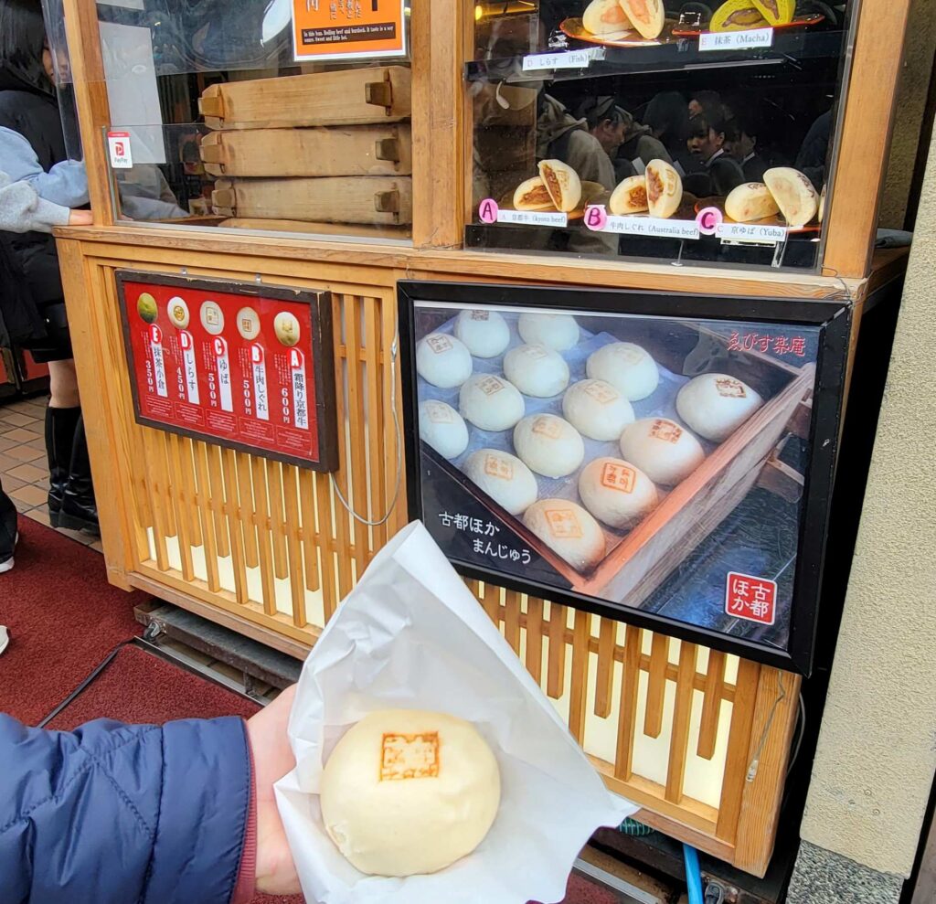 Kyoto beef steam bun in front of food stall selling various buns in Kiyomizu temple area in  Kyoto.