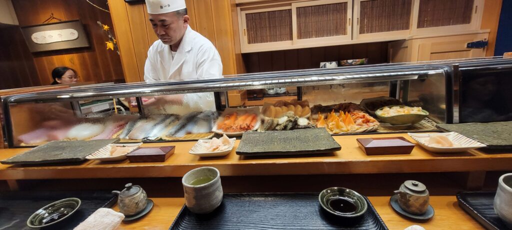 View from counter seating and master sushi chef preparing food at Sushi Ichijo Tokyo, a MICHELIN Guide Restaurant.