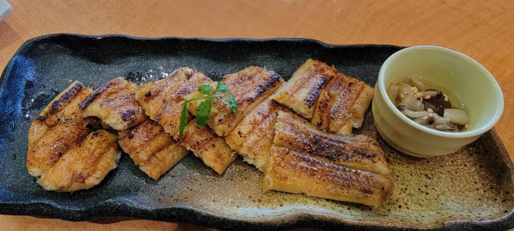 "Hamo" or grilled conger eel, cut in pieces and served in a rectangular plate.