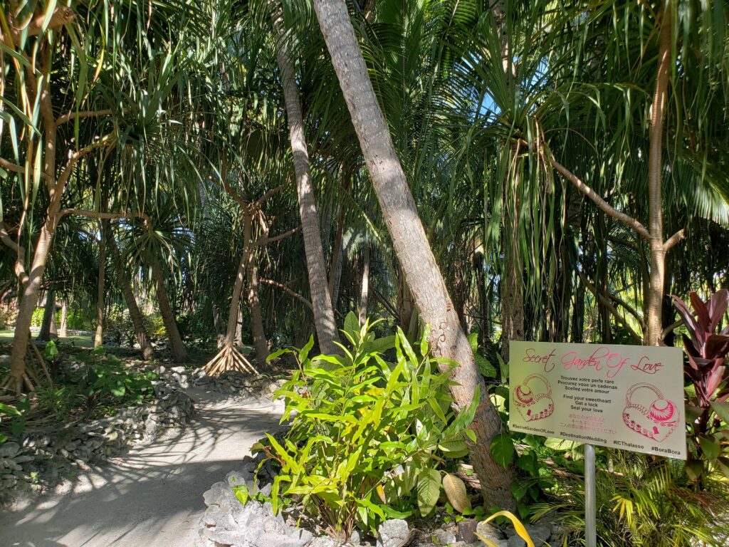 Trees and signage at the entrance of the Secret Garden of Love at InterContinental Bora Bora & Thalasso Spa.