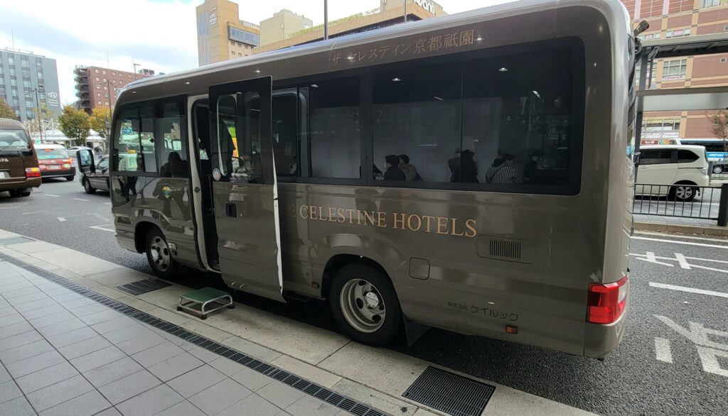 Free shuttle bus parked at Kyoto Station for Hotel The Celestine Kyoto Gion, waiting for guests.