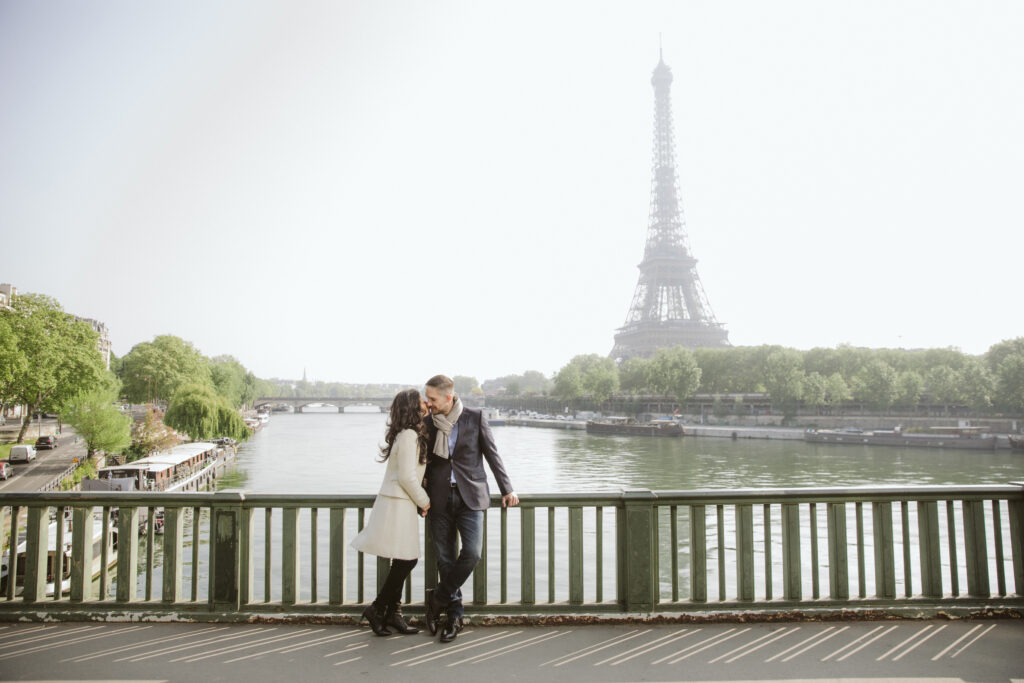 Flytographer photo shoot is one of our top travel tips to capture vacation photos like this one of couple in Paris with Eiffel Tower in background.  